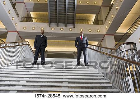 Portrait of a businessmen standing on staircase View Large Photo Image Stock Photography - Portrait of a businessmen standing on staircase. Fotosearch