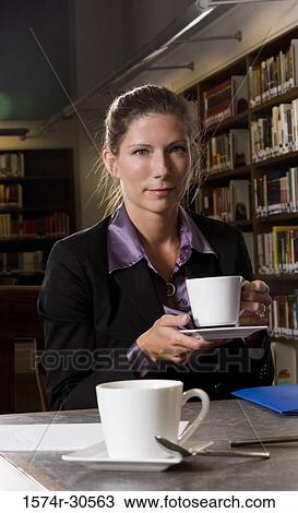 Portrait of a businesswoman holding tea cup in an office View Large Photo Image Stock Image - Portrait of a businesswoman holding tea cup in an office. Fotosearch
