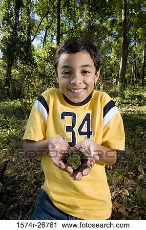 Portrait of a cheerful boy holding a frog in his palm at forest View Large Photo Image Stock Image - Portrait of a cheerful boy holding a frog in his palm at forest. Fotosearch