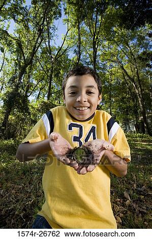 Portrait of a cheerful boy holding a frog in his palm at forest View Large Photo Image Stock Image - Portrait of a cheerful boy holding a frog in his palm at forest. Fotosearch