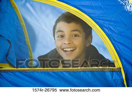 Portrait of a cheerful boy looking through tent View Large Photo Image Stock Photography - Portrait of a cheerful boy looking through tent. Fotosearch