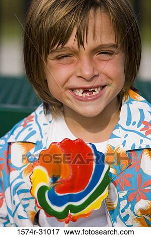 Portrait of a cheerful boy with lollipop View Large Photo Image Stock Photo - Portrait of a cheerful boy with lollipop. Fotosearch