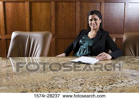 Portrait of a cheerful businesswoman sitting on armchair in an office View Large Photo Image Stock Photo - Portrait of a cheerful businesswoman sitting on armchair in an office. Fotosearch