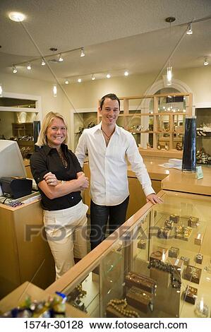 Portrait of a cheerful couple standing in a store View Large Photo Image Stock Photo - Portrait of a cheerful couple standing in a store. Fotosearch