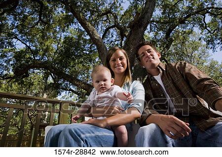 Portrait of a cheerful family relaxing on armchairs View Large Photo Image Stock Image - Portrait of a cheerful family relaxing on armchairs. Fotosearch