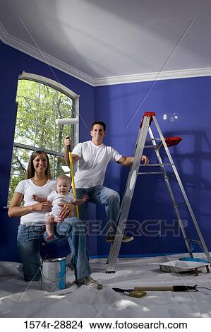 Portrait of a cheerful family with step ladder and paint roller in house View Large Photo Image Picture - Portrait of a cheerful family with step ladder and paint roller in house. Fotosearch