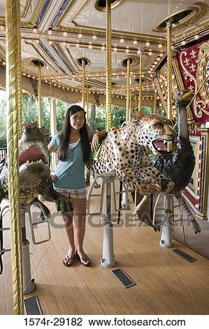 Portrait of a cheerful girl standing in a carousel by a carousel leopard View Large Photo Image Stock Image - Portrait of a cheerful girl standing in a carousel by a carousel leopard. Fotosearch