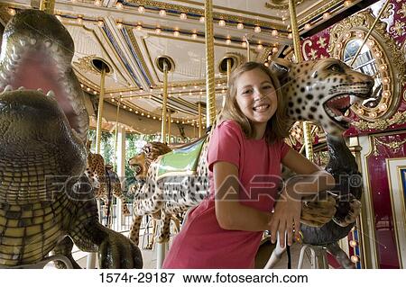 Portrait of a cheerful girl standing in a carousel View Large Photo Image Stock Photo - Portrait of a cheerful girl standing in a carousel. Fotosearch