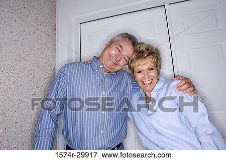 Stock Photo - Portrait of a cheerful mature couple standing together. Fotosearch