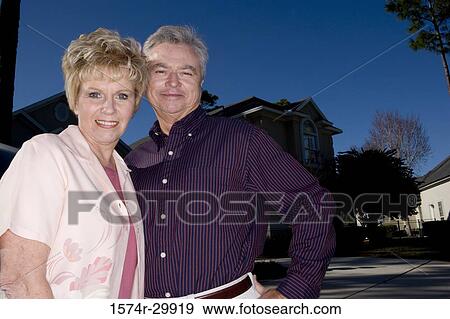 Portrait of a cheerful mature couple standing together View Large Photo Image Stock Photo - Portrait of a cheerful mature couple standing together. Fotosearch