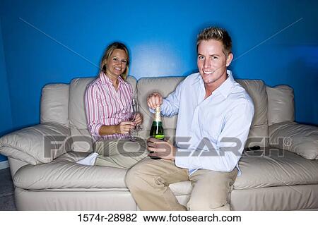 Portrait of a cheerful mid adult couple holding wineglasses and bottle View Large Photo Image Stock Image - Portrait of a cheerful mid adult couple holding wineglasses and bottle. Fotosearch