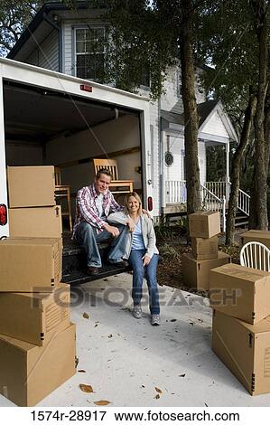 Portrait of a cheerful mid adult couple sitting in moving van View Large Photo Image Stock Photo - Portrait of a cheerful mid adult couple sitting in moving van. Fotosearch