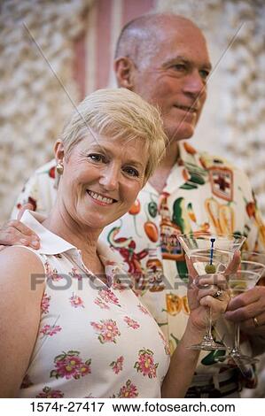 Portrait of a cheerful senior woman and man holding wineglass View Large Photo Image Stock Photo - Portrait of a cheerful senior woman and man holding wineglass. Fotosearch