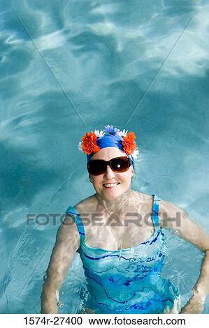 Portrait of a cheerful senior woman swimming in swimming pool View Large Photo Image Stock Image - Portrait of a cheerful senior woman swimming in swimming pool. Fotosearch
