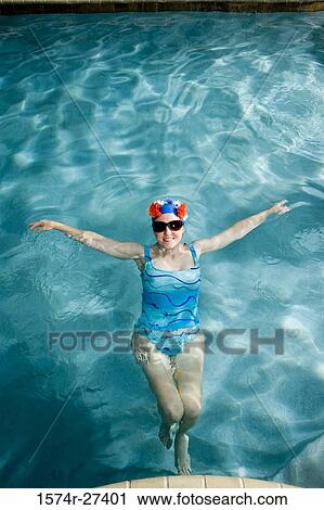Portrait of a cheerful senior woman swimming in swimming pool View Large Photo Image Stock Image - Portrait of a cheerful senior woman swimming in swimming pool. Fotosearch