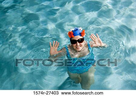 Portrait of a cheerful senior woman swimming in swimming pool View Large Photo Image Stock Image - Portrait of a cheerful senior woman swimming in swimming pool. Fotosearch