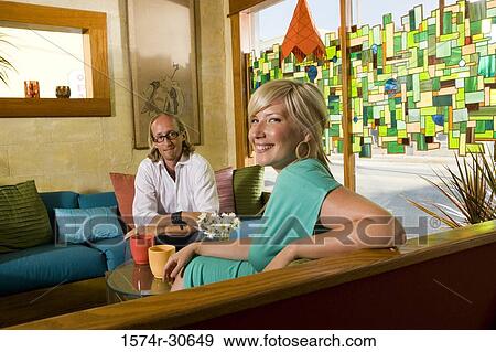 Portrait of a cheerful woman and man sitting together View Large Photo Image Stock Photo - Portrait of a cheerful woman and man sitting together. Fotosearch