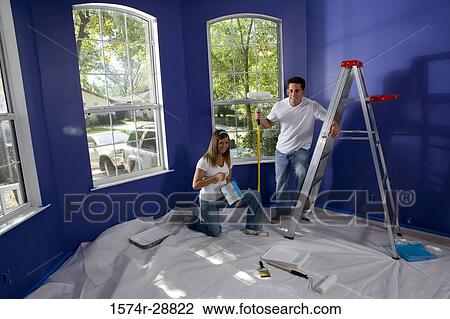Portrait of a cheerful young couple with step ladder and paint roller in house View Large Photo Image Stock Image - Portrait of a cheerful young couple with step ladder and paint roller in house. Fotosearch
