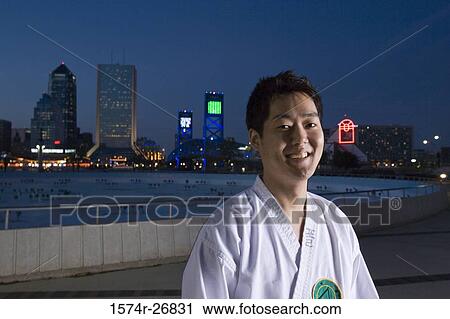 Stock Image - Portrait of a cheerful young man in sports uniform. Fotosearch