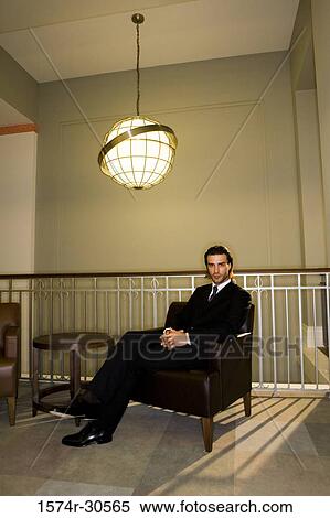 Portrait of a contemplative businessman sitting on armchair in an office View Large Photo Image Stock Photography - Portrait of a contemplative businessman sitting on armchair in an office. Fotosearch