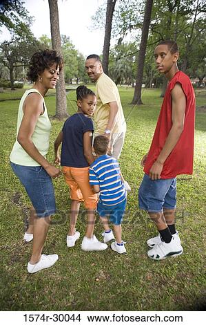Portrait of a family running at park View Large Photo Image Picture - Portrait of a family running at park. Fotosearch
