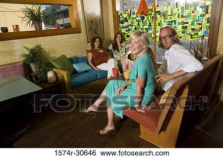 Portrait of a family sitting together and smiling View Large Photo Image Stock Photograph - Portrait of a family sitting together and smiling. Fotosearch