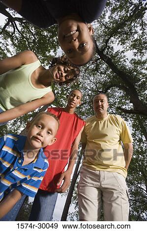 Portrait of a family standing at park View Large Photo Image Stock Photo - Portrait of a family standing at park. Fotosearch