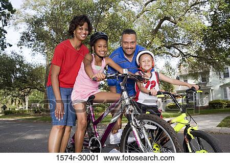 Portrait of a family standing with bicycle on the road View Large Photo Image Stock Image - Portrait of a family standing with bicycle on the road. Fotosearch