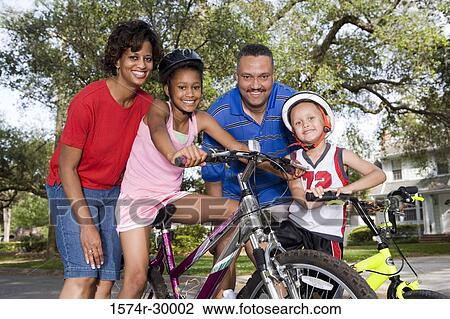 Portrait of a family standing with bicycle on the road View Large Photo Image Stock Image - Portrait of a family standing with bicycle on the road. Fotosearch