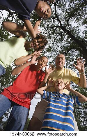 Portrait of a family sticking out tongue and making a face at park View Large Photo Image Stock Image - Portrait of a family sticking out tongue and making a face at park. Fotosearch