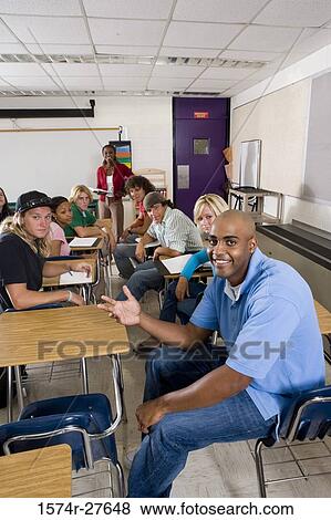 Stock Photo - Portrait of a female teacher teaching students in the classroom. Fotosearch