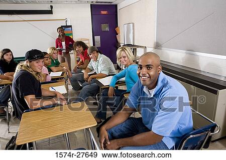 Portrait of a female teacher teaching students in the classroom View Large Photo Image Stock Photo - Portrait of a female teacher teaching students in the classroom. Fotosearch