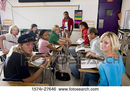 Portrait of a female teacher teaching students in the classroom View Large Photo Image Stock Photograph - Portrait of a female teacher teaching students in the classroom. Fotosearch