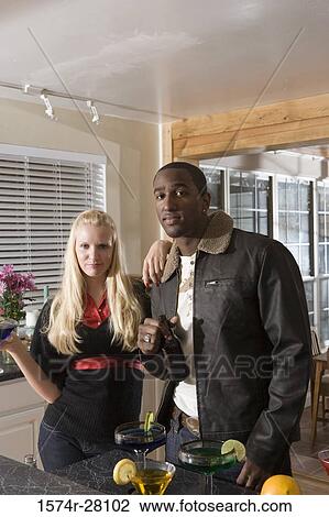 Portrait of a friends standing with wines in domestic kitchen View Large Photo Image Stock Image - Portrait of a friends standing with wines in domestic kitchen. Fotosearch