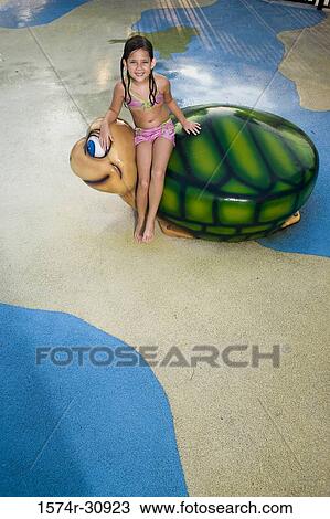 Portrait of a girl sitting on a tortoise sculpture View Large Photo Image Stock Image - Portrait of a girl sitting on a tortoise sculpture. Fotosearch