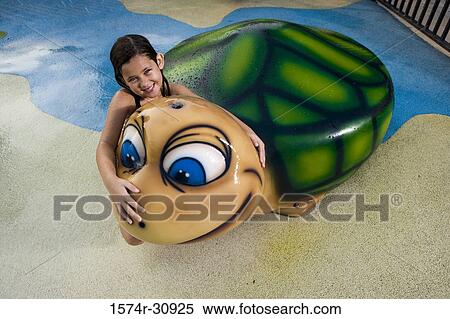 Portrait of a girl sitting on a tortoise sculpture View Large Photo Image Stock Photography - Portrait of a girl sitting on a tortoise sculpture. Fotosearch