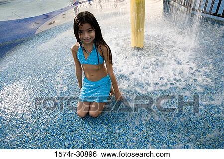 Portrait of a girl sitting under a shower View Large Photo Image Stock Photograph - Portrait of a girl sitting under a shower. Fotosearch
