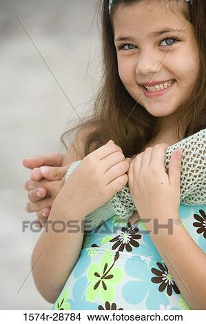 Portrait of a girl smiling by woman View Large Photo Image Picture - Portrait of a girl smiling by woman. Fotosearch