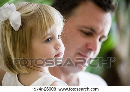 Portrait of a girl with her father in the background View Large Photo Image Stock Photo - Portrait of a girl with her father in the background. Fotosearch