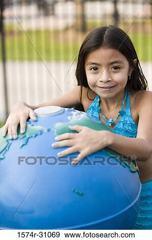 Portrait of a girl with inflated globe View Large Photo Image Stock Photo - Portrait of a girl with inflated globe. Fotosearch