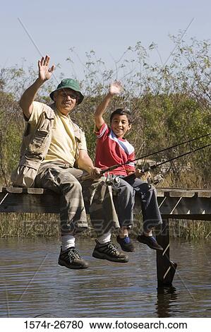Portrait of a grandfather fishing with his grandson at the lake View Large Photo Image Stock Image - Portrait of a grandfather fishing with his grandson at the lake. Fotosearch