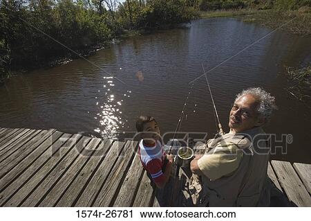 Portrait of a grandfather fishing with his grandson at the lake View Large Photo Image Stock Image - Portrait of a grandfather fishing with his grandson at the lake. Fotosearch