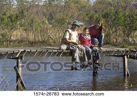 Portrait of a grandfather fishing with his grandson at the lake View Large Photo Image Stock Image - Portrait of a grandfather fishing with his grandson at the lake. Fotosearch