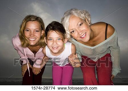 Portrait of a grandmother enjoying with her daughter and granddaughter at the beach View Large Photo Image Picture - Portrait of a grandmother enjoying with her daughter and granddaughter at the beach. Fotosearch