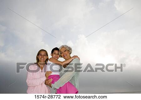 Portrait of a grandmother enjoying with her daughter and granddaughter against sky View Large Photo Image Stock Image - Portrait of a grandmother enjoying with her daughter and granddaughter against sky. Fotosearch