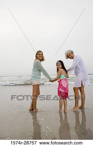 Portrait of a grandmother enjoying with her daughter and granddaughter at the beach View Large Photo Image Stock Photo - Portrait of a grandmother enjoying with her daughter and granddaughter at the beach. Fotosearch