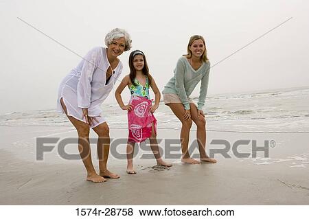 Portrait of a grandmother enjoying with her daughter and granddaughter at the beach View Large Photo Image Stock Photo - Portrait of a grandmother enjoying with her daughter and granddaughter at the beach. Fotosearch