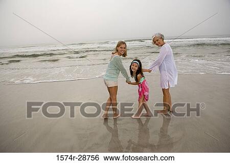 Portrait of a grandmother enjoying with her daughter and granddaughter at the beach View Large Photo Image Stock Photograph - Portrait of a grandmother enjoying with her daughter and granddaughter at the beach. Fotosearch