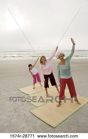 Portrait of a grandmother exercising with daughter and granddaughter at the beach View Large Photo Image Stock Image - Portrait of a grandmother exercising with daughter and granddaughter at the beach. Fotosearch