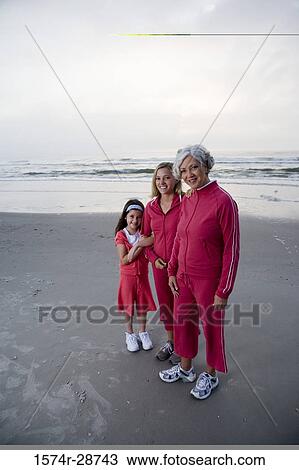 Portrait of a grandmother standing with her daughter and granddaughter at the beach View Large Photo Image Stock Image - Portrait of a grandmother standing with her daughter and granddaughter at the beach. Fotosearch